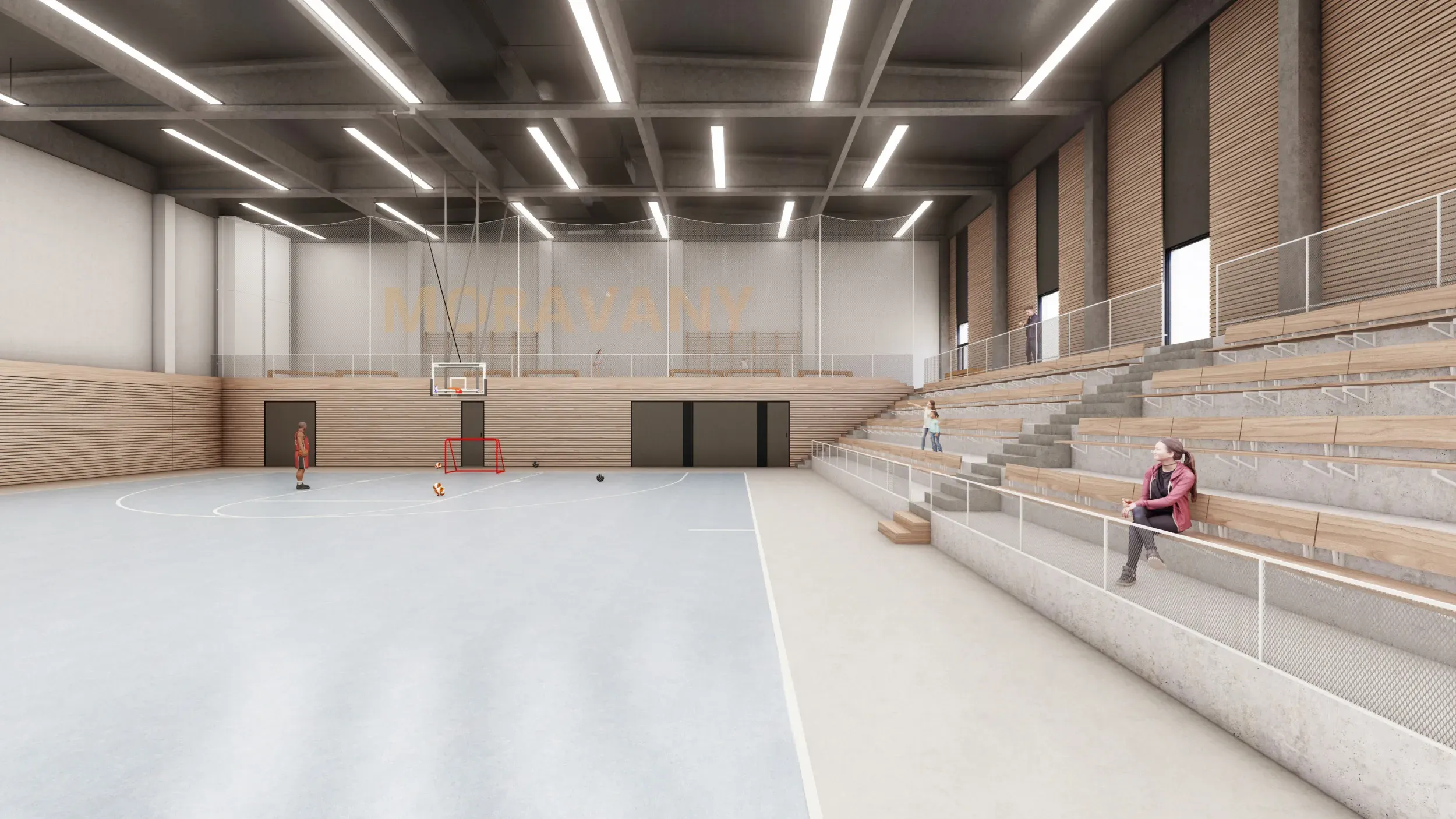 Pohled z hrací plochy vedle tribuny. Je zde vidět uspořádání sezení, na hrací ploše potom branka a basketbalový koš, na zdi za hrací plochou je průchod do technických prostor a šaten.